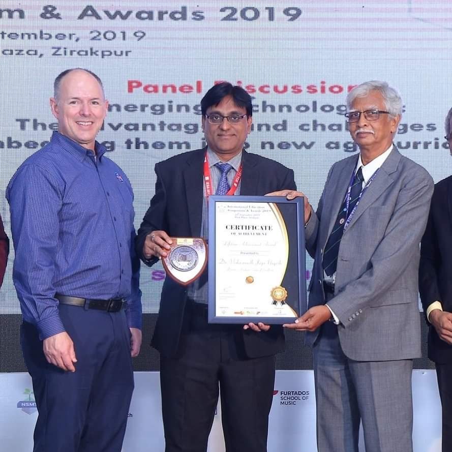 Dr. V J Nagesh receiving the Lifetime Achievement Award at the International Education Symposium